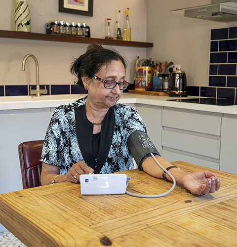 Lady using Blood Pressure Monitor